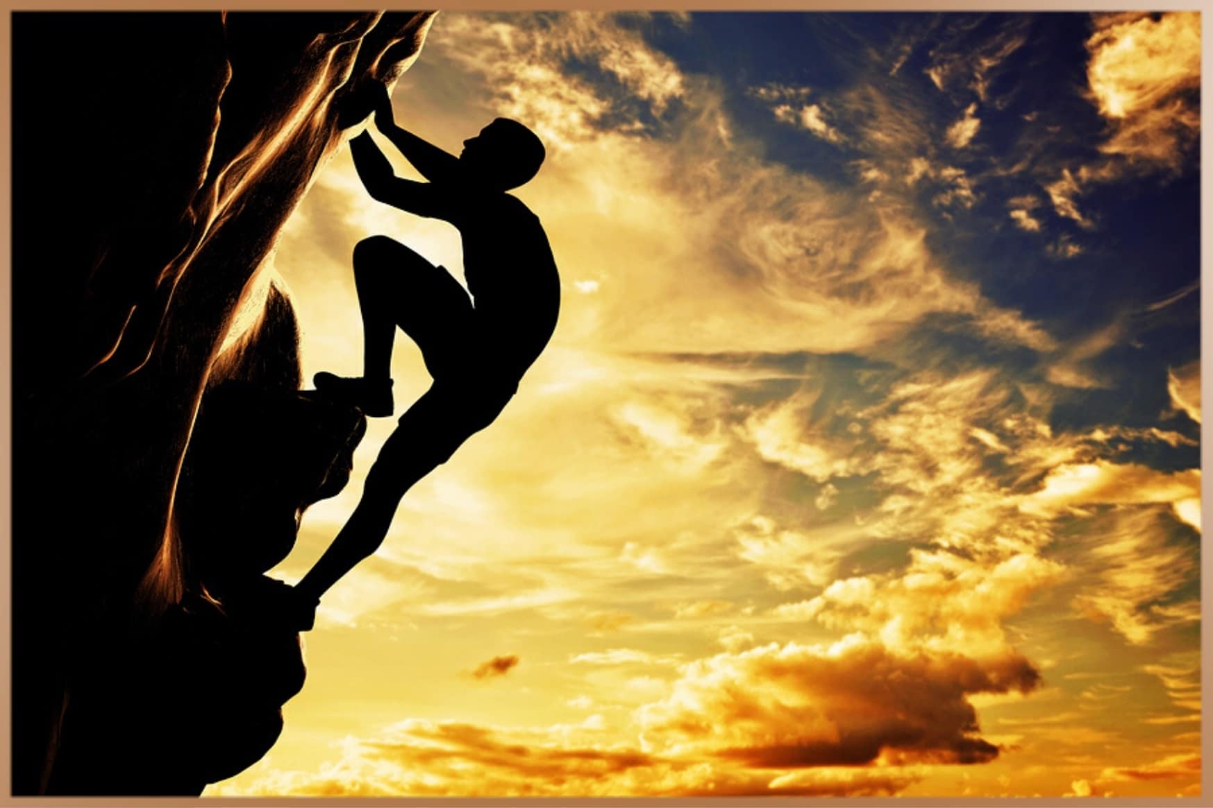 Man climbs a rock at sunset with a cloudy sky background