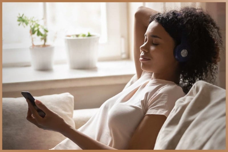 Woman practices meditation with meditation app on her phone
