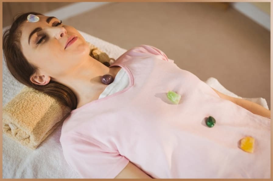 Crystals on a woman's body during crystal healing therapy session