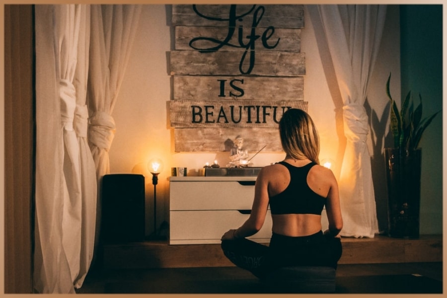 Woman practices meditation at home with mantra: Life is beautiful