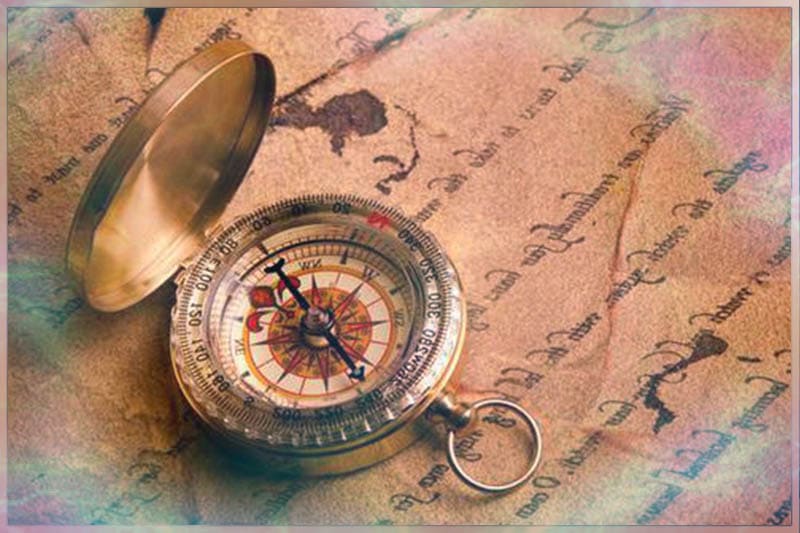 Old beautiful compass on a handwritten letter