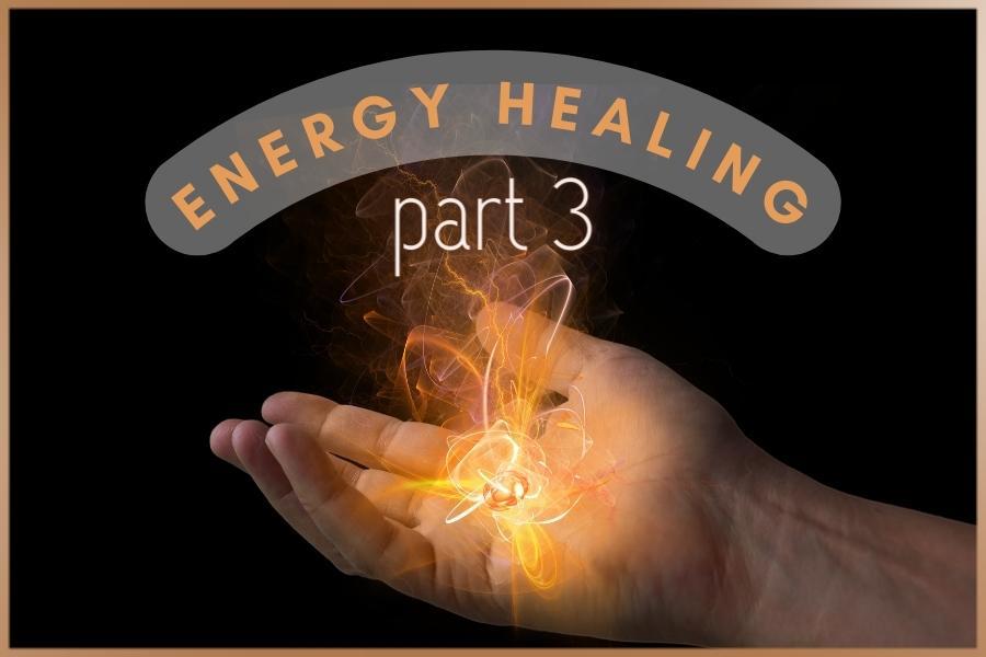 Hand of the spiritual or energy healer and bright orange energy around it