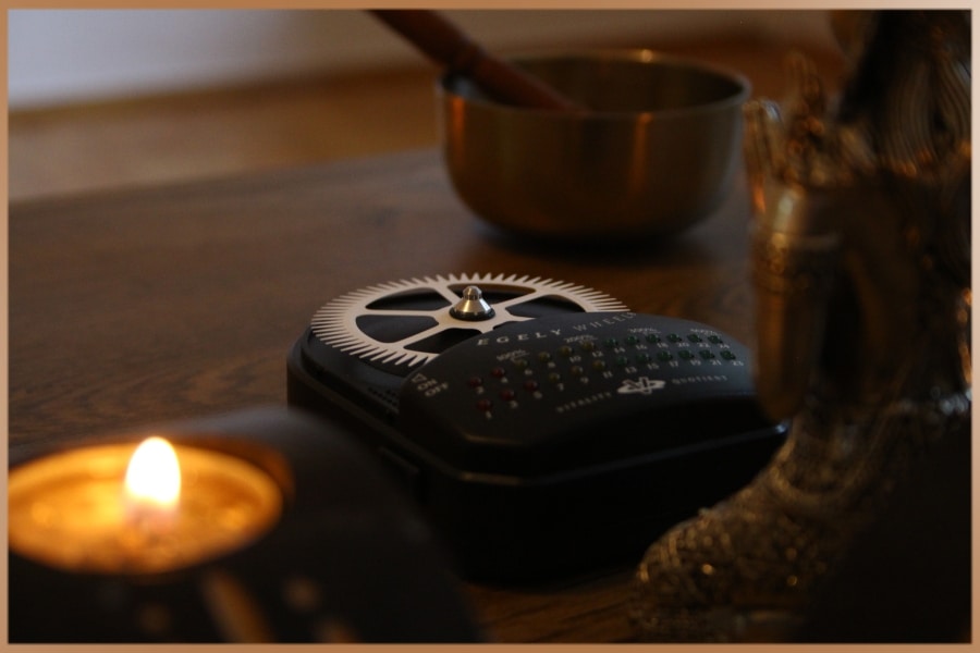 Peaceful setting with candle light, spiritual objects and Egely Wheel