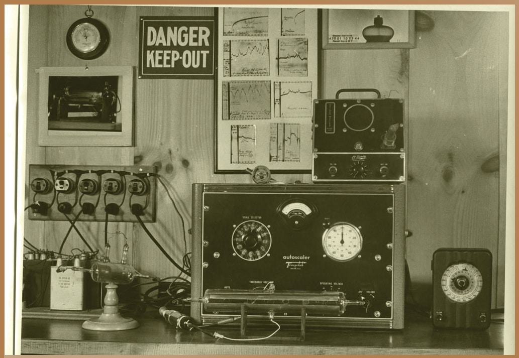 Sepia-toned photograph of Wilhelm Reich's research equipment at the Orgone Institute Archives, with devices, gauges, and charts, reflecting the experimental approach to studying orgone energy.